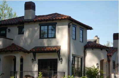 Stucco sided home with clay roof